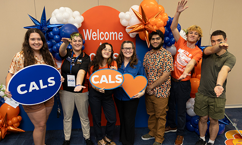 CALS students holding signs in front of a CALS backdrop. Photo taken 08-22-23, UF/IFAS Photo by Tyler Jones